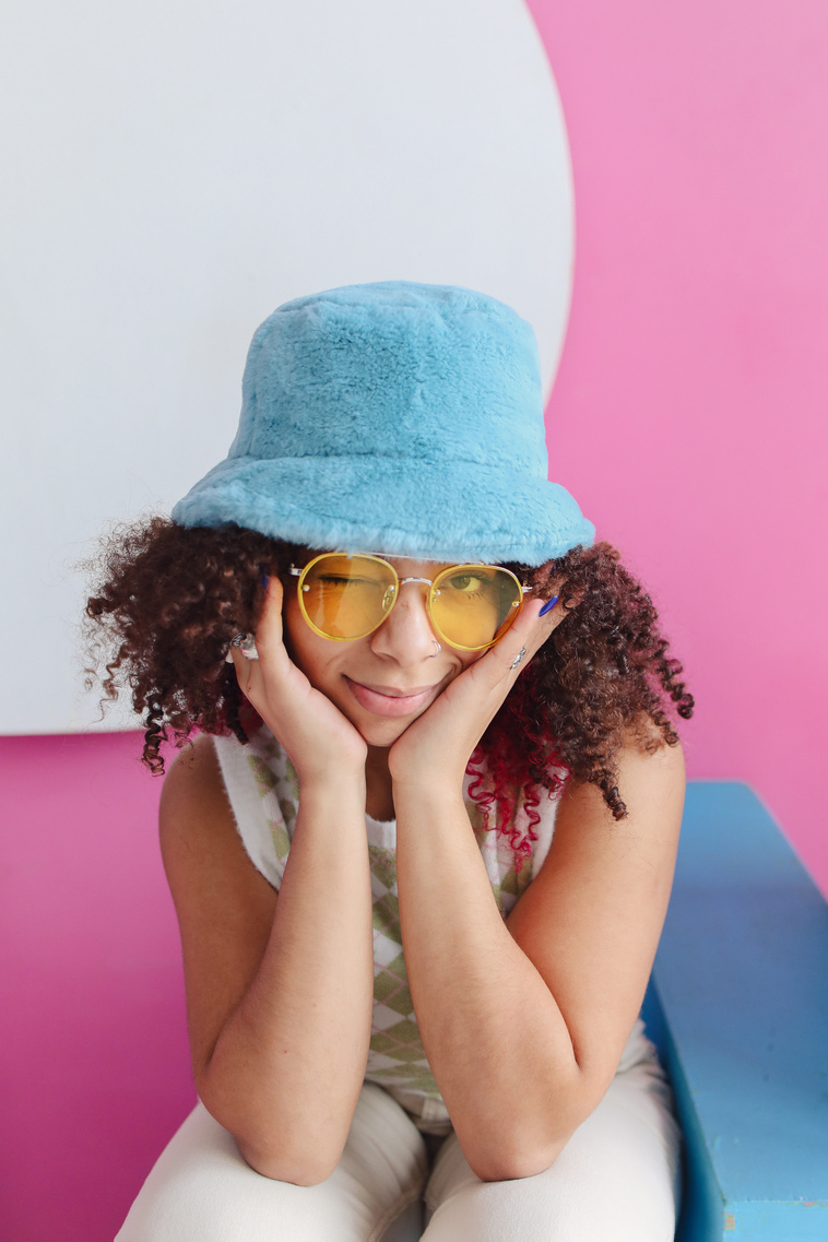Young Woman in Sunglasses and Bucket Hat